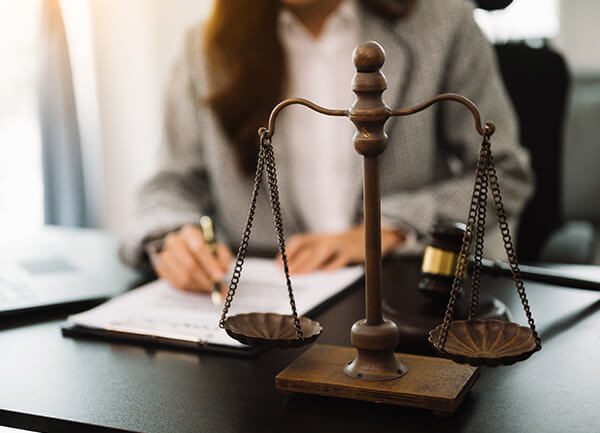 home-3-hover-image-3 gavel with books old wooden desk