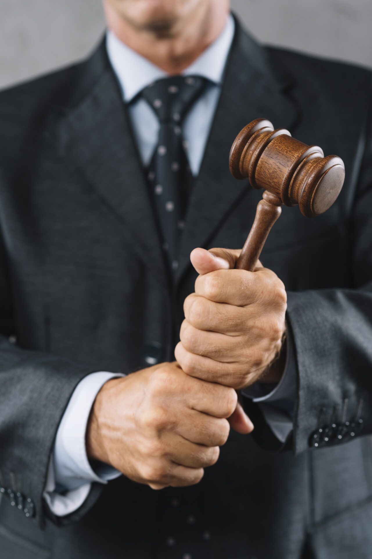 mid-section-male-lawyer-holding-wooden-mallet-hand mid section male lawyer holding wooden mallet hand